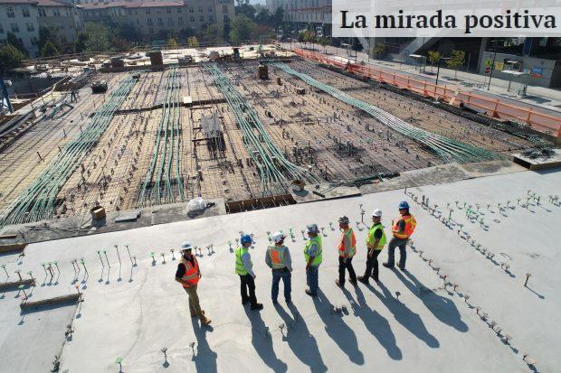 seven construction workers standing on white field