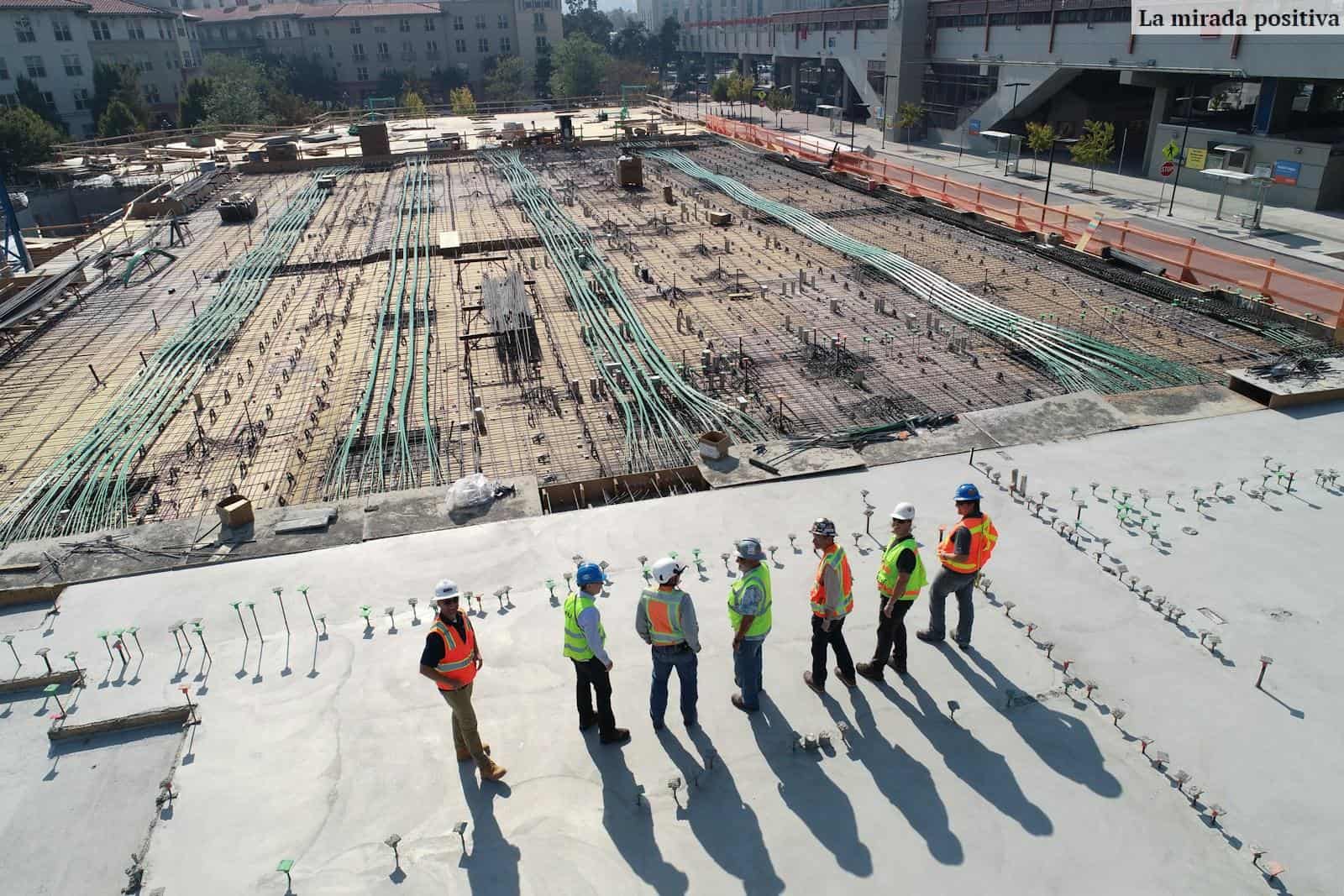 seven construction workers standing on white field
